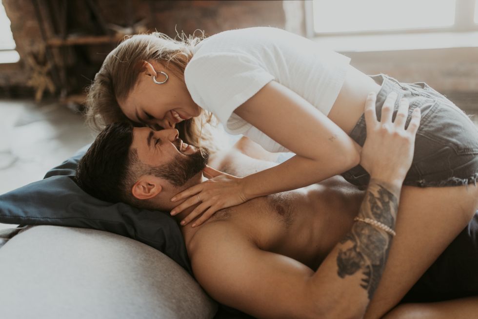 couple in loving embrace, foreheads touching, woman sitting on man